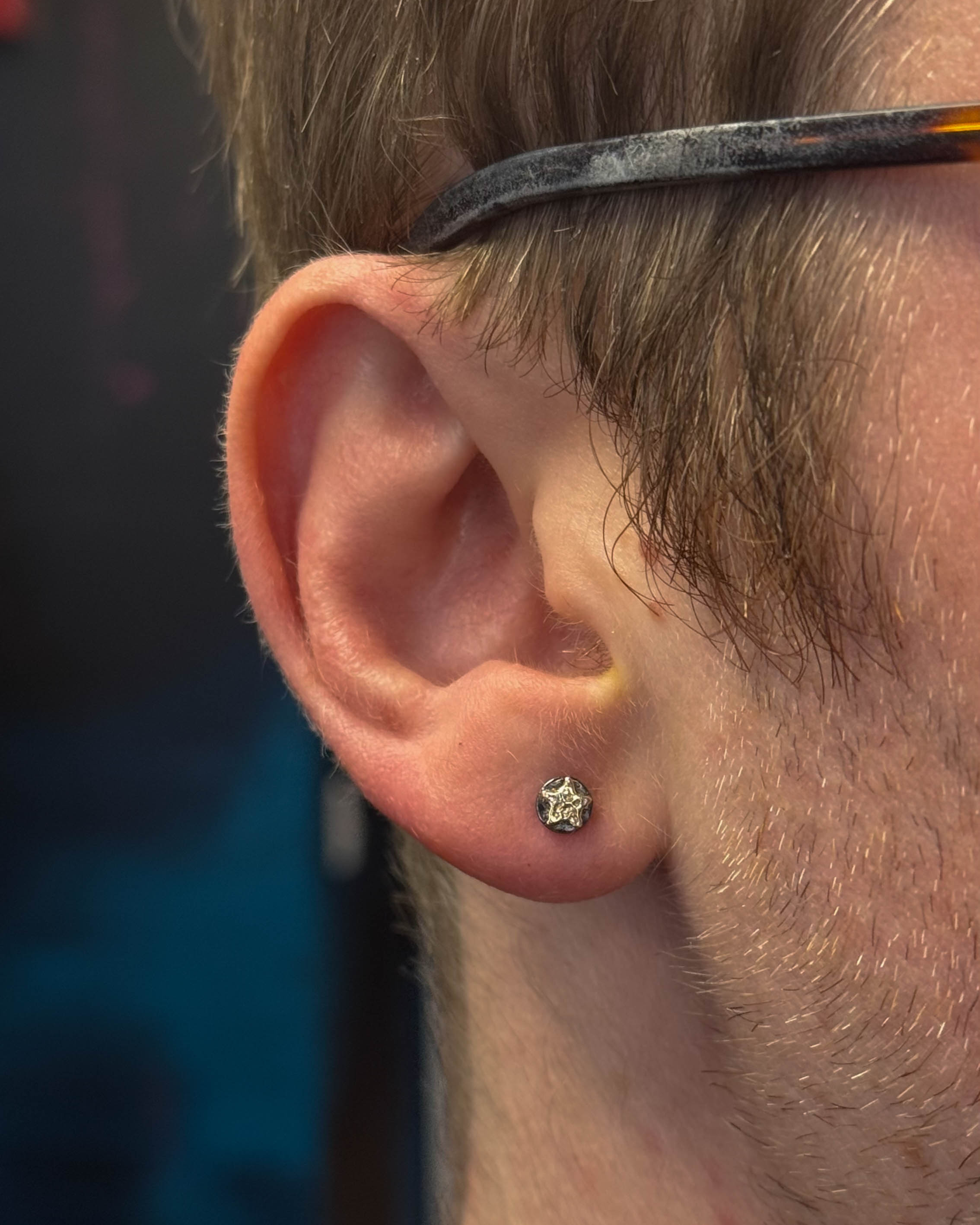 Bobby's freshly pierced lobe — clean placement by Stab Daddy Bri